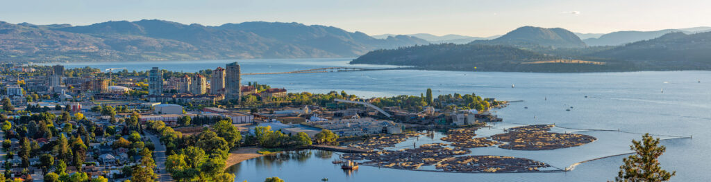 Waterfront view of Kelowna with hilly landscape in the background